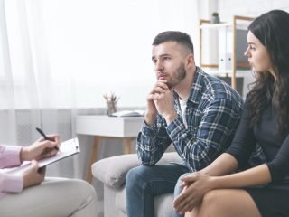 Young grumpy couple at marital counseling therapy